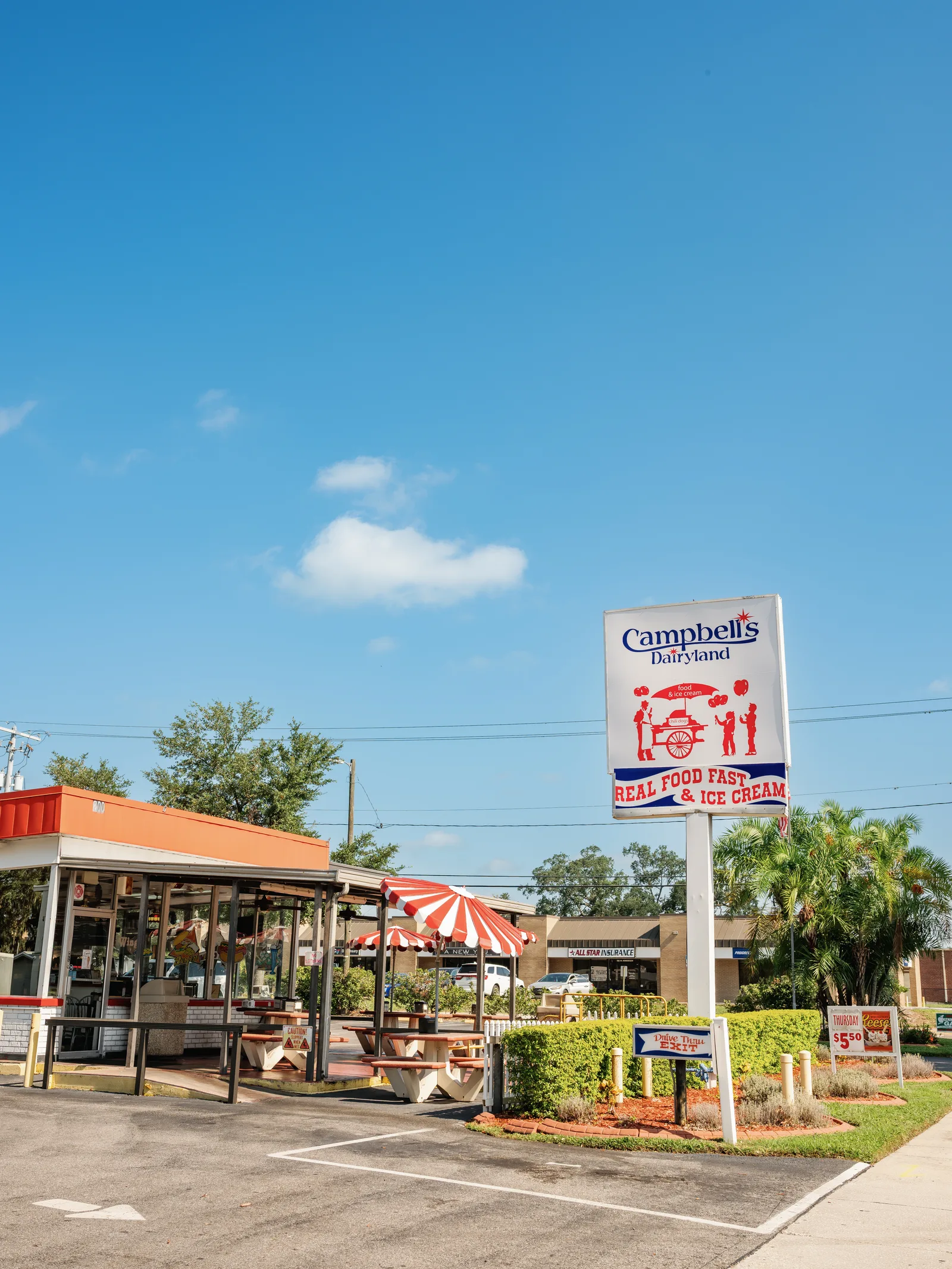 Campbell's Dairyland exterior with patio umbrellas in Brandon